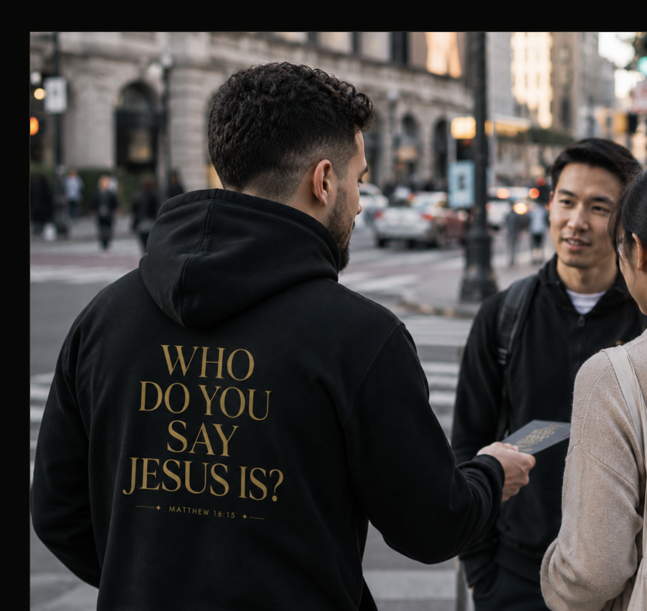 Black Evangelist hoodie photographed from behind on a city street, gold back lettering reading “Who do you say Jesus is?” with the Matthew 16:15 citation.
